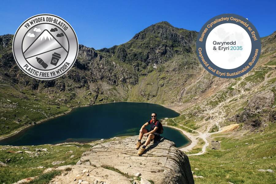 Plastic-free business pledge badges displayed over a mountain lake in Eryri National Park