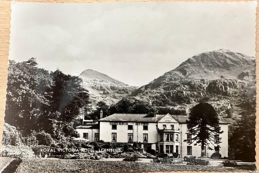 Historic photograph of Royal Victoria Hotel with gardens and frontage set beneath Yr Wyddfa in Llanberis