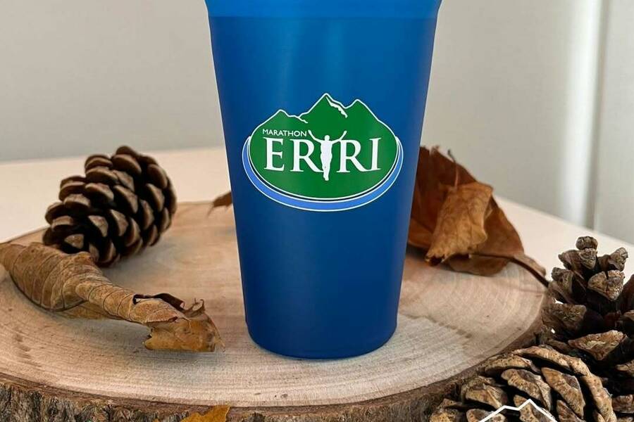 Blue reusable cup branded with the Eryri logo, promoting sustainable events in Eryri National Park