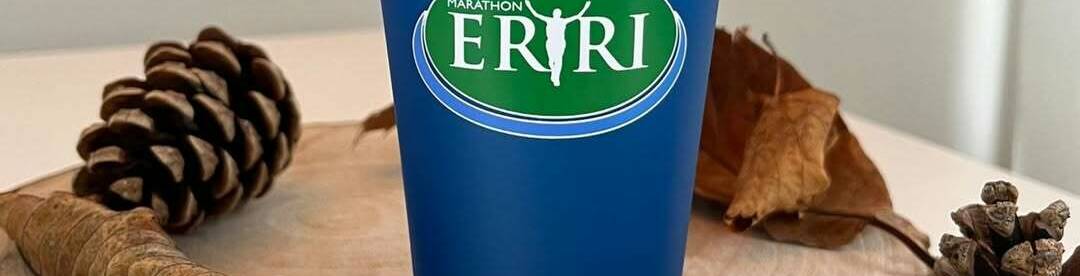Blue reusable cup branded with the Eryri logo, promoting sustainable events in Eryri National Park