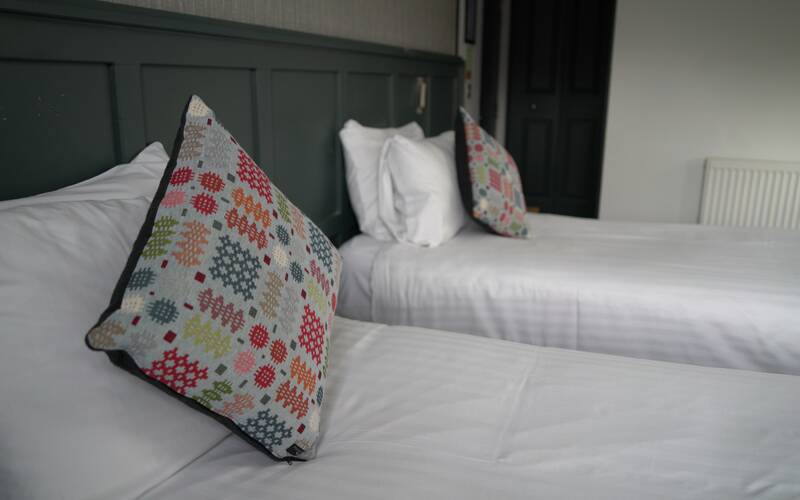 Twin room with decorative cushions