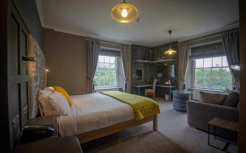 The Slate Room at the Royal Victoria Hotel Llanberis featuring a modern ensuite and soft furnishings.